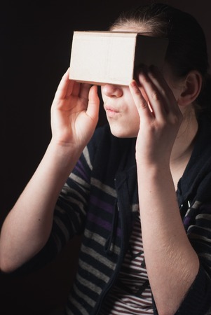 the emotions of a young girl looking through cardboard VR,の写真素材
