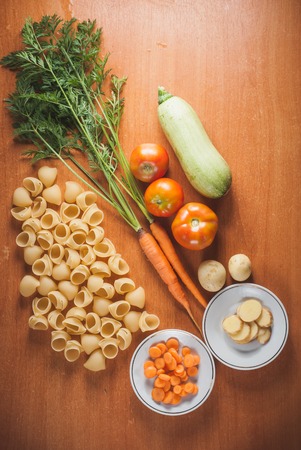 organic food on a wooden table, the pasta and set of vegetables, vegetarian cookingの写真素材