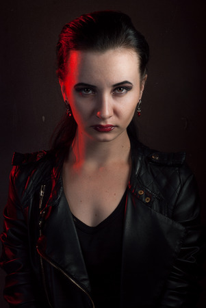 girl in a black leather jacket, the image of a vampire on Halloween, rock star posing with aggressive appearanceの写真素材
