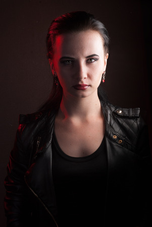 girl in a black leather jacket, the image of a vampire on Halloween, rock star posing with aggressive appearanceの写真素材