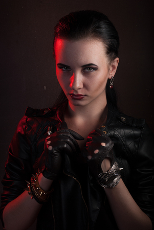 girl in a black leather jacket, the image of a vampire on Halloween, rock star posing with aggressive appearanceの写真素材