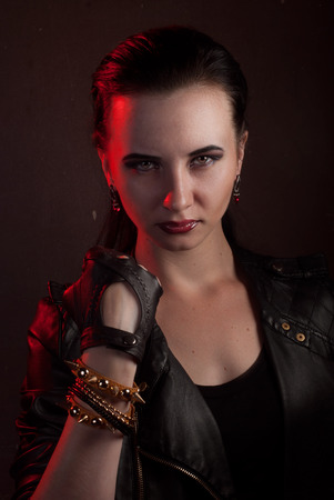 girl in a black leather jacket, the image of a vampire on Halloween, rock star posing with aggressive appearanceの写真素材