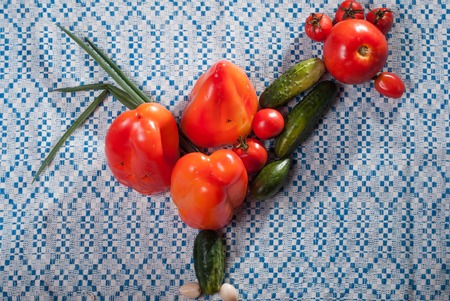 fresh ripe vegetables on a towel, harvest, set of vegetables in the shape of a roosterの写真素材
