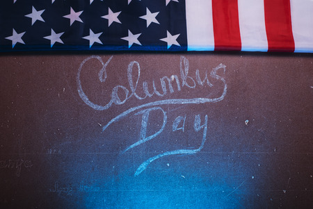 The text on the Board and an American flag, happy Columbus Dayの写真素材