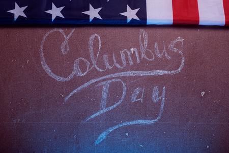 The text on the Board and an American flag, happy Columbus Dayの写真素材