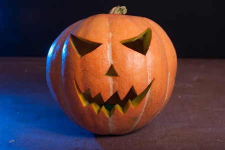 Jack-o ' - lantern on a wooden table, happy Halloweenの写真素材