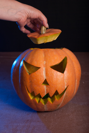 Jack-o ' - lantern on a wooden table, happy Halloweenの写真素材