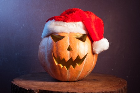 Jack-o ' - lantern in a red Santa hat, happy holidaysの写真素材