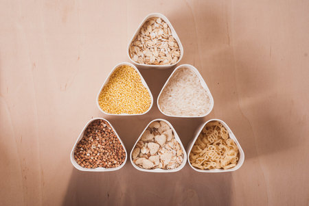 Collection of cereals, grains: rice, oats, buckwheat, millet, wooden table, country kitchen, white...