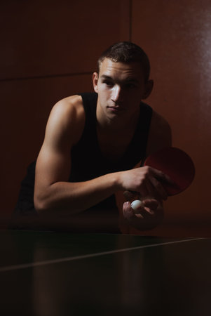 Closeup ping pong, table tennis player, a serious young man in a black shirt, dark atmospheric style