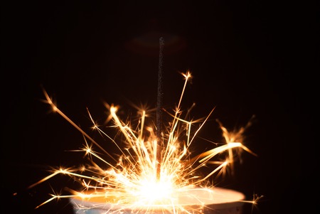 the Sparkler in a paper Cup on a black background, sparks fly in different directions, Christmas atmosphereの写真素材