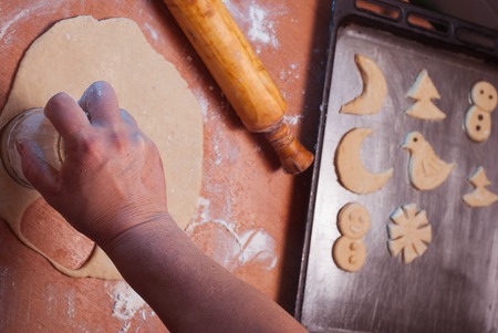 The dough is ready for baking Christmas cookies, hands spread out the dough on a baking tray, cookの写真素材