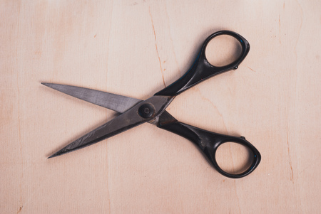 Vintage steel scissors on wooden table with copy space.の写真素材
