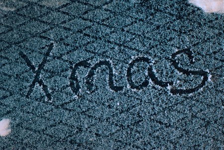 write x-mas in the snow, the snow on iron background, inscription,の写真素材