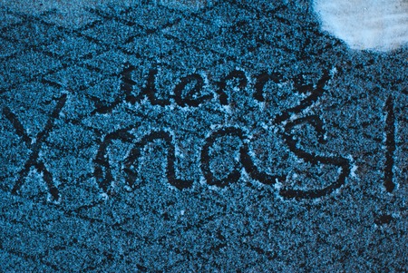 write merry x mas in the snow, the snow on iron background, inscription, happy holidaysの写真素材