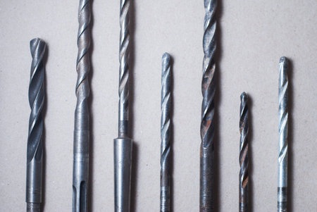 set of drill bits on wooden background.
