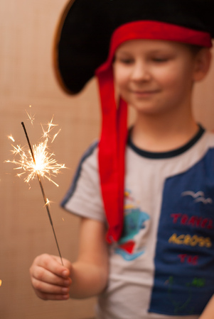 portrait of a young boy, pirate hat, Christmas tree, the Sparklerの写真素材