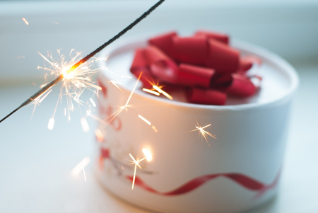 The gift on the table, Sparkler, white box with a red ribbon,の写真素材