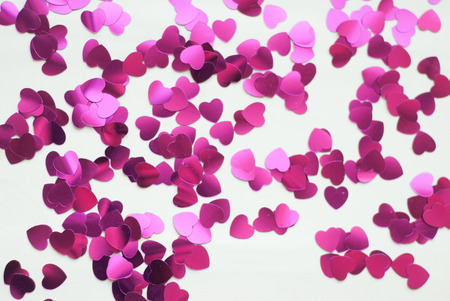 Confetti hearts on a white background, pink confetti in honor of Valentine's day, template for postcardの写真素材