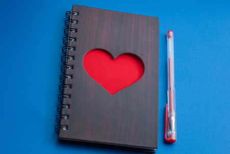 A notebook with a large red heart on a blue background, gel pen, top view, Valentineの写真素材