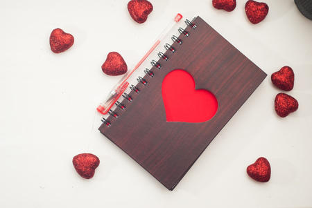 Notepad on white background, large Valentine decorative heartsの写真素材