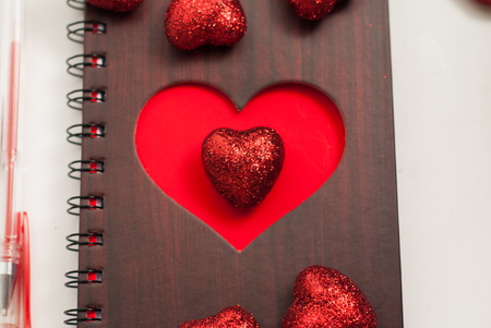 Notepad on white background, large Valentine decorative heartsの写真素材