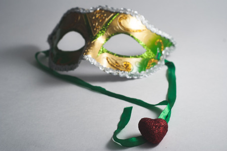 yellow green Venetian in disfocused, decorative heart, the concept of carnival, Gras Mardiの写真素材