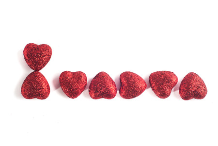 Decorative red heart isolated on a white background, the inscription of hearts, March 8の写真素材