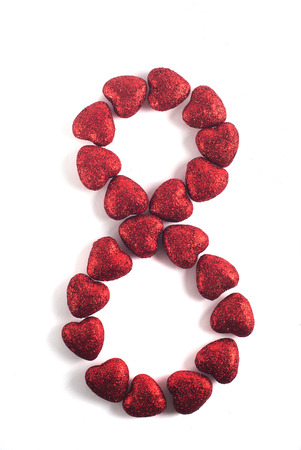 Decorative red heart isolated on white background, in the form of a figure eight, on March 8, international women's dayの写真素材