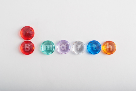 The inscription March 8, faceted colored stones on a white background, international women's day, template for postcardの写真素材