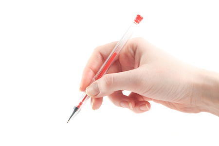Female hand is ready for drawing with a red pen Isolated on white. gel penの写真素材