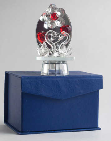 Crystal Swan on a grey background, elegant souvenir glass, blue boxの写真素材