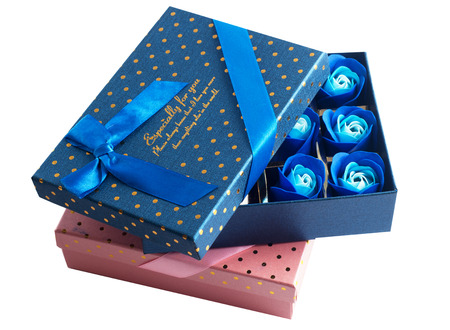 Gift box closeup and blue rose buds isolated on white backgroundの写真素材