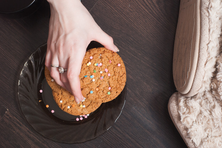 Female hand takes cookies from the plate,の写真素材