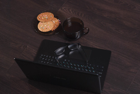 Workplace with laptop, Cup of hot coffee,の写真素材