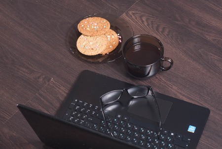 Workplace with laptop, Cup of hot coffee,の写真素材
