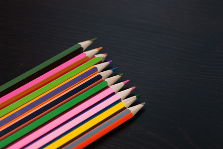 Colored pencils set on black wood background, drawing materials, large set,の写真素材