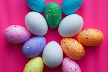 Decorative eggs on pink background, happy Easter, top viewの写真素材