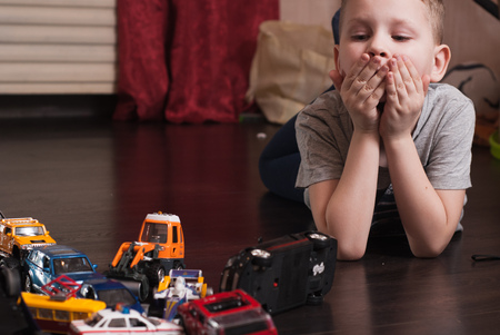 Surprised child, a traffic jam of toy cars, little boy playing, the emergency situation on the road, the conceptualの写真素材