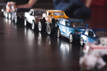 traffic jam of toy cars, emergency, children's toys on a wooden floorの写真素材