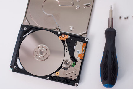 Took apart the hard drive from the computer, HDD drive, mirror effect, screwdriver with rubber...