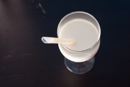 A glass of milk on a black background, healthy drink,の写真素材