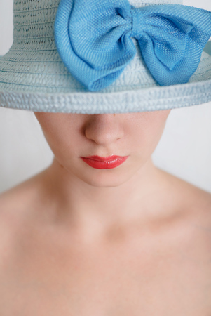 Beautiful girl in a blue hat, naked body,の写真素材