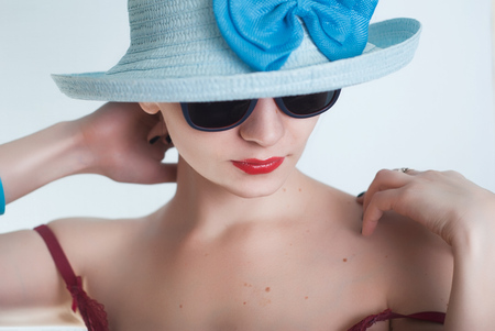 Beautiful girl in a blue hat and sunglasses,の写真素材