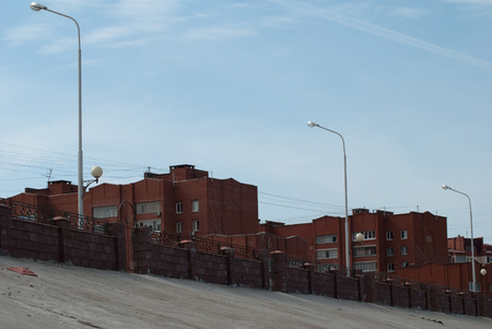 A multi-storey building of red brick against the blue skyの写真素材