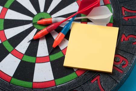 Dart hit the center of the target and attaches the sticker, the concept of achieving goals - Darts and businessの写真素材
