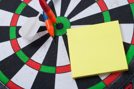 Dart hit the center of the target and attaches the sticker, the concept of achieving goals - Darts and businessの写真素材