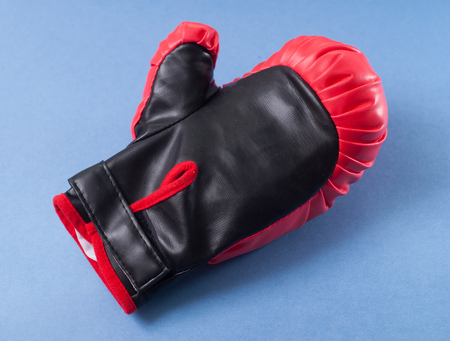Boxing gloves red leather on a blue backgroundの写真素材