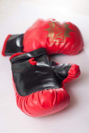 red Boxing gloves in leather on white background, selective focusの写真素材