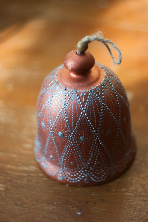 closeup photo of a bell on a rope made from clay,の写真素材